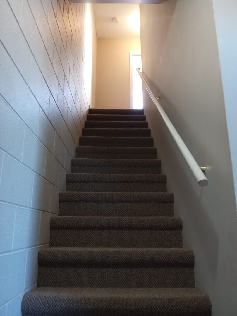 A stairway leading to a room with a door.