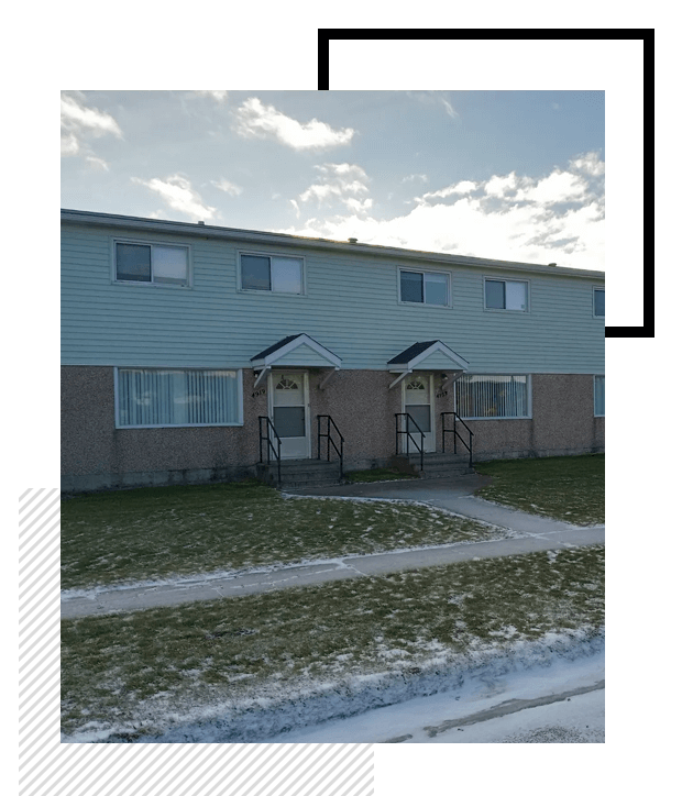 A picture of a building with snow on the ground.