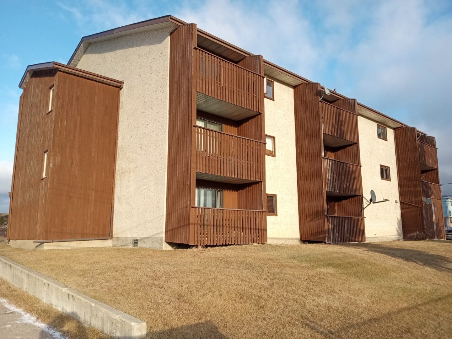 A building with brown siding and white trim.