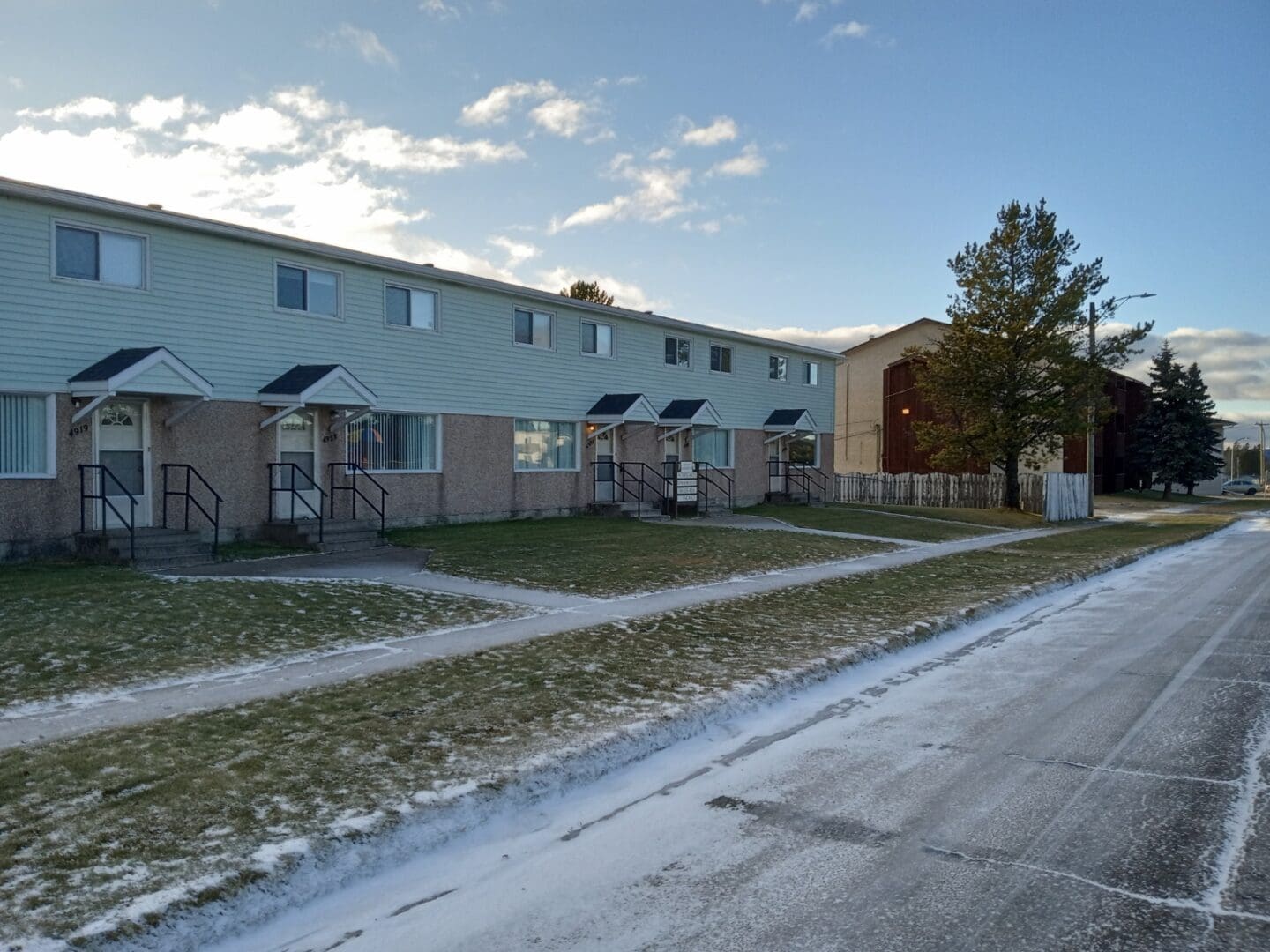 A row of houses on the side of a street.